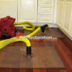 Vacuum drying panel on a wood floor beside a door