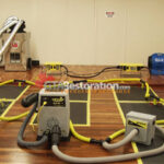 Air movers and hoses around floor drying panels