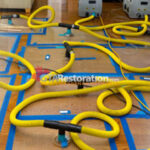 Specialty drying floor panels connected to yellow hoses