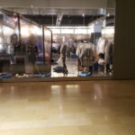 Restoration workers and drying equipment in a shop entrance.