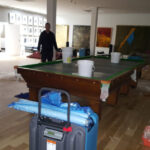 Blue drying equipment on a trolley beside a pool table.