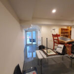 Floodwater across a furnished basement with a kitchen.
