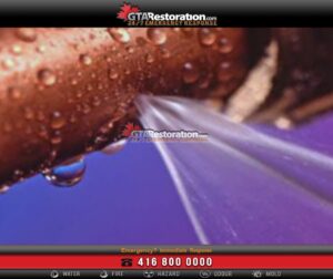 Water spraying from a damaged copper pipe during a plumbing emergency