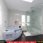 Walk-in shower with glass enclosure