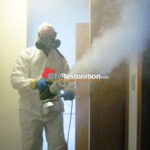 Technician inspecting smoke-damaged room