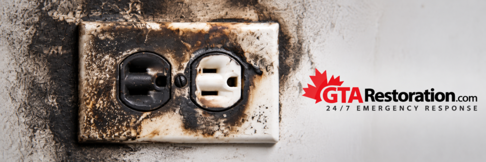 Soot residue and fire damage around an electrical outlet